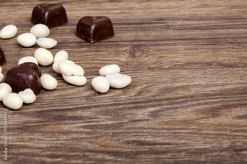 Healthy type candy from dried fruit in chocolate. Shot on wood type background