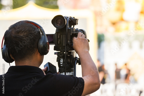 professional cameraman - covering on the event with a video 