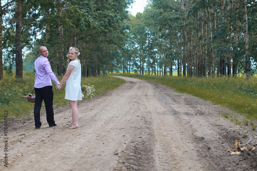 Fototapeta premium Just married lovers walking in a field in autumn day