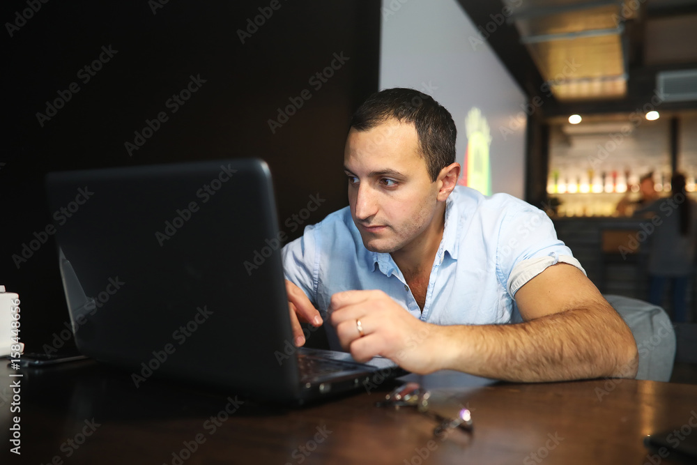 Armenian handsome man working behind laptop Armenian handsome man working behind laptop