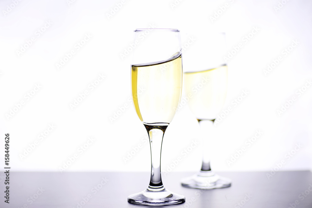 glass of white wine on a table on white background isolate