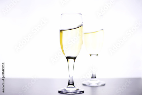 glass of white wine on a table on white background isolate