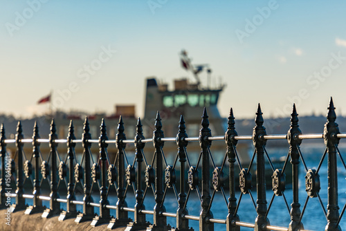Fotografia Cast iron railings at Circular Quay and ferry on the background