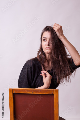 Woman posing in fashion style in studio on gray background. Sexy lady. Perfect beautiful attractive female posing in model test in studio