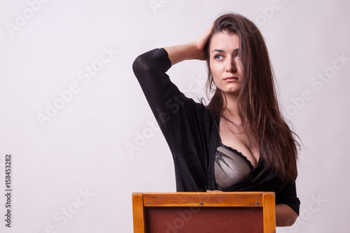 Sensual busty lady on gray background. Sexy lady. Perfect beautiful attractive female posing in model test in studio