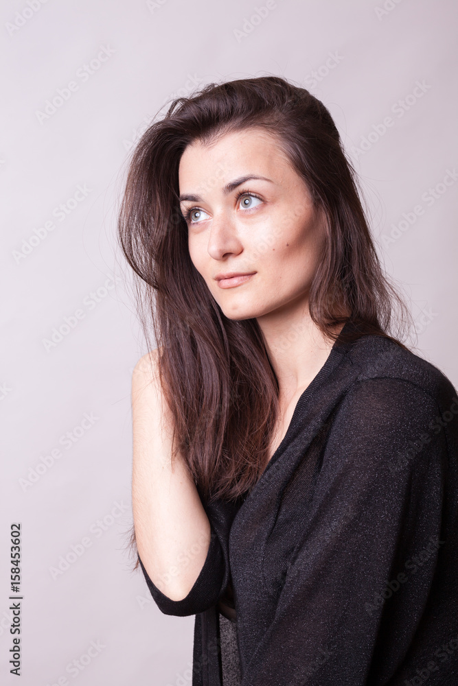 Portrait of gorgeous woman posing in studio on gray background. Sexy lady. Perfect beautiful attractive female posing in model test in studio Portrait of gorgeous woman posing in studio on gray background. Sexy lady. Perfect beautiful attractive female posing in model test in studio