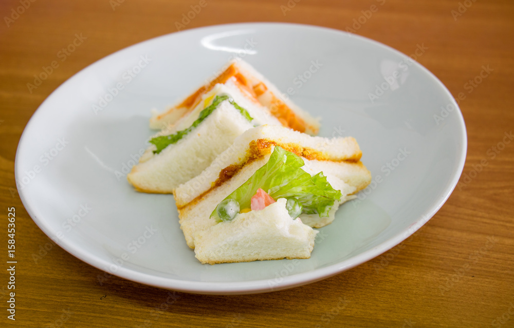 delicious sandwich with ham vegeable bread on white dish , home made sandwich, health food delicious sandwich with ham vegeable bread on white dish , home made sandwich, health food