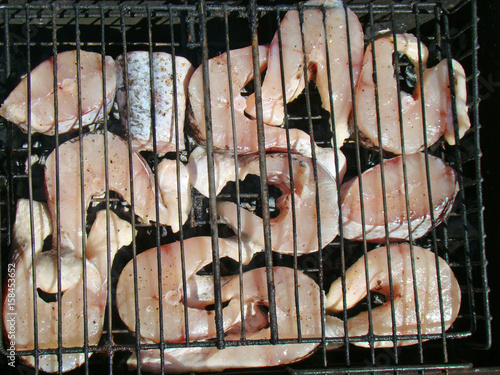 Raw fish steaks on the grill
