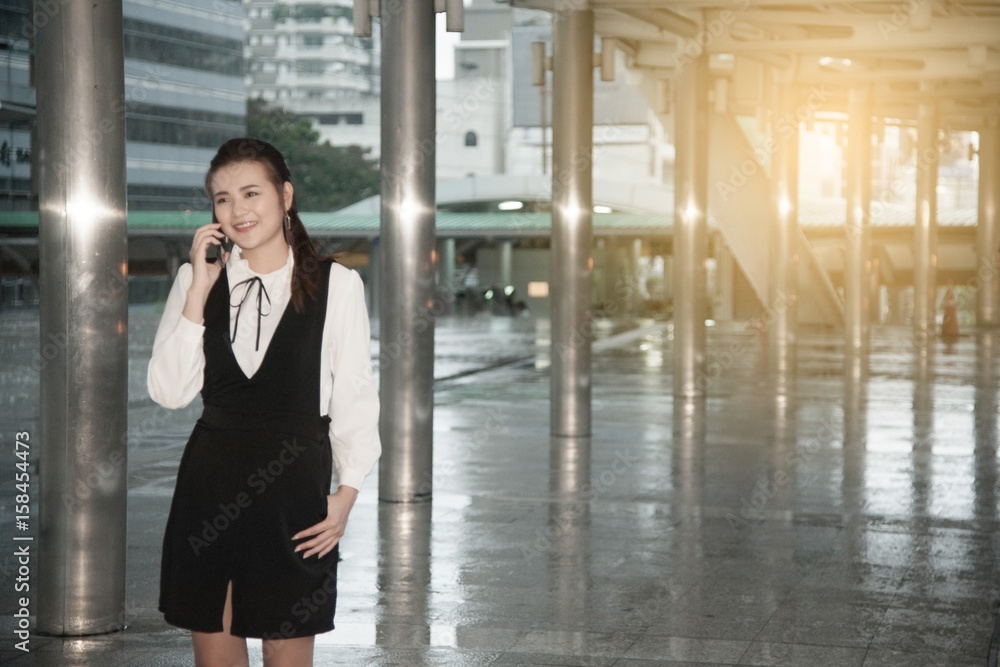 Asian pretty woman use smartphone at landmark bridge crossing in city. Asian pretty woman use smartphone at landmark bridge crossing in city.