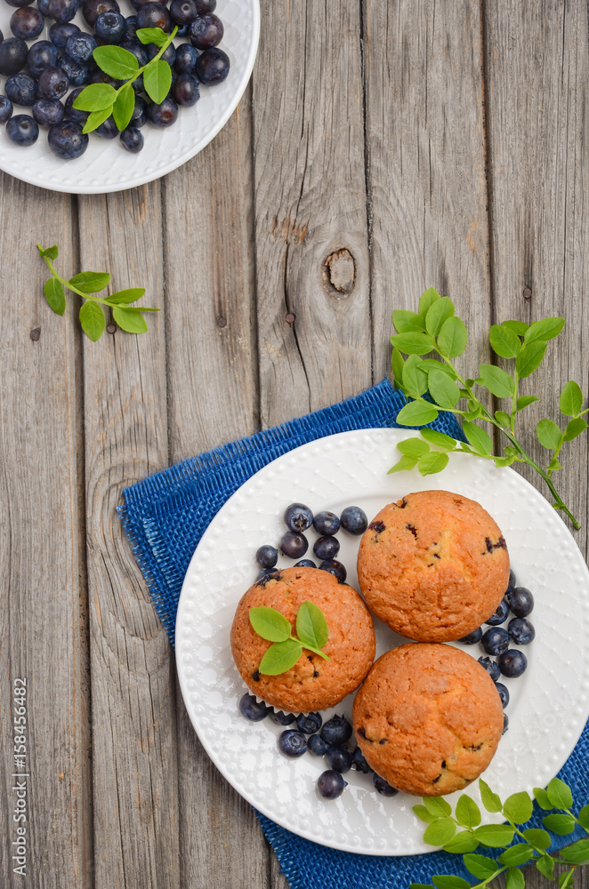 Homemade blueberry muffins on rustic wooden background, top view, copy space Homemade blueberry muffins on rustic wooden background, top view, copy space