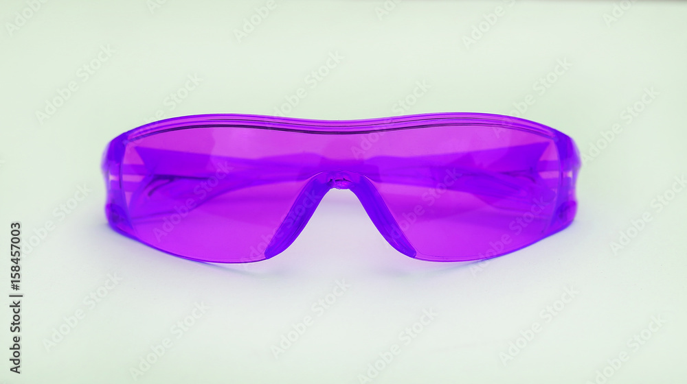 Fototapeta premium Purple safety glasses on white background.