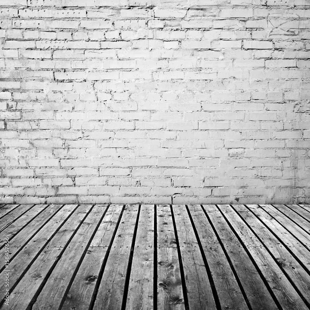 White brick wall and gray wooden floor White brick wall and gray wooden floor