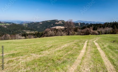 mountain meadow with hills on the background and clear sky in Javorniky mountains in Slovakia photo