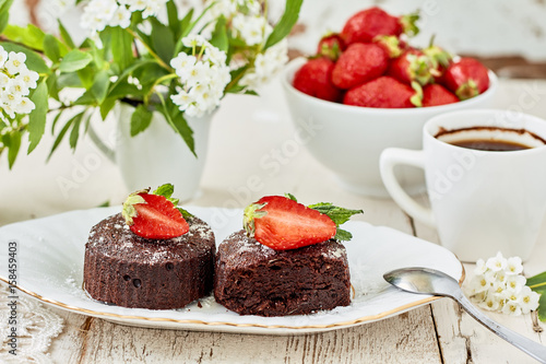 Chocolate  Muffin  with strawberries, mint and powdered sugar