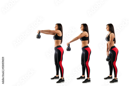 Slender brunette woman doing exhalation with weight on biceps on white isolated background, view from left side, stage exercises on biceps