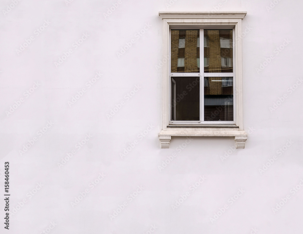 Beautiful window on white plaster wall