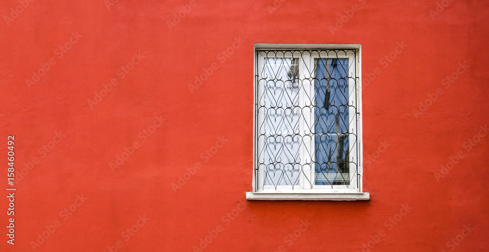 Window on red wall