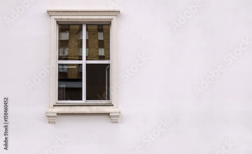 Beautiful window on white plaster wall © Maksim