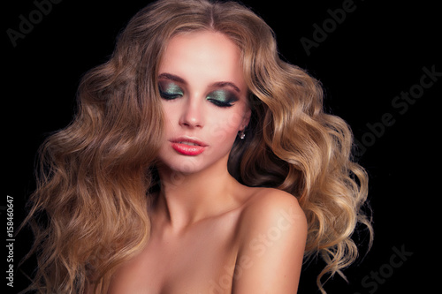 Beauty Fashion Model Woman , portrait, hairstyle with creative hair-dress, curls waves. Concept Girl face with perfect skin in dark Background