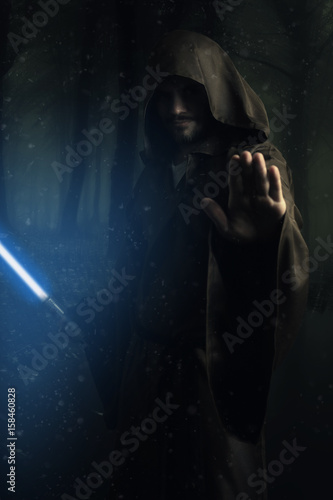 Quadro em tela Mysterious warrior holding a lightsaber