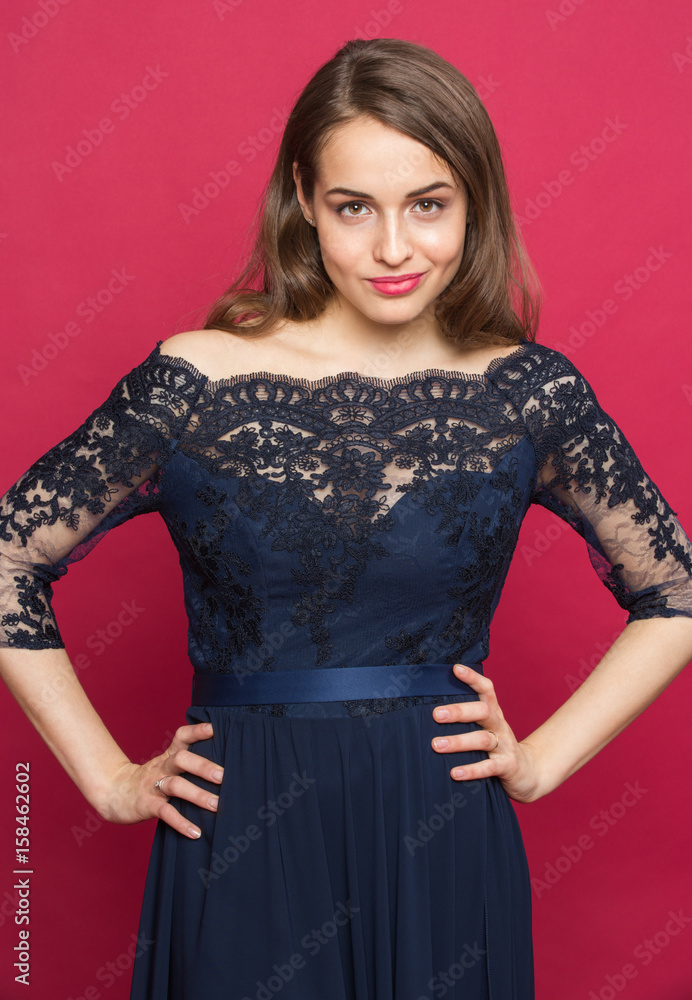 Girl in a beautiful dress on a colored background staring into the frame Girl in a beautiful dress on a colored background staring into the frame