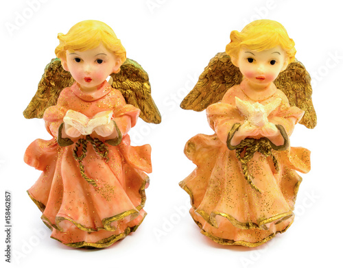 Statuettes of porcelain angels with book and pigeon isolated on white background