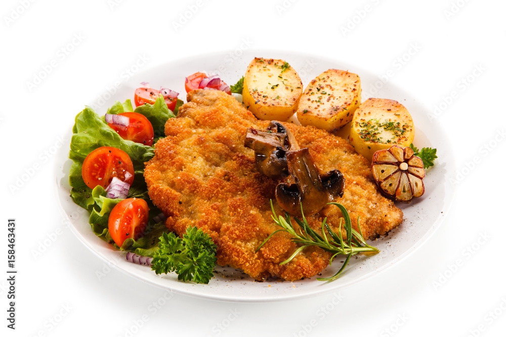 Fried pork chop with potatoes on white background Fried pork chop with potatoes on white background