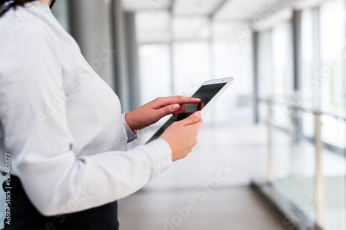 Modern business women holding tablet and toucing it © Alvin Harambašić