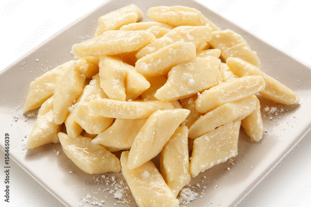 Potato noodles - dumplings on white background Potato noodles - dumplings on white background