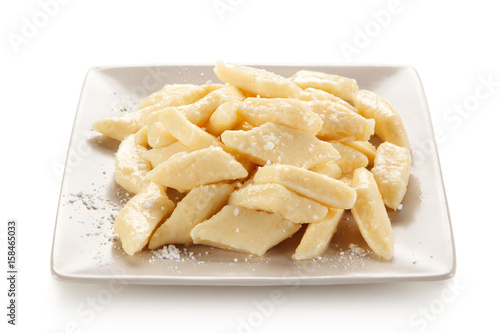 Potato noodles - dumplings on white background
