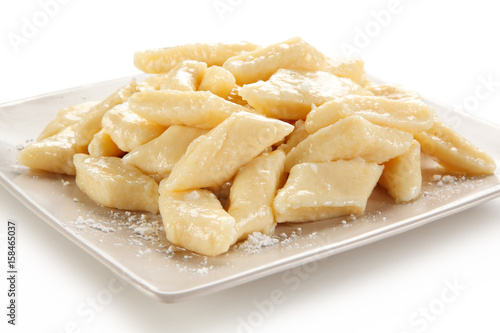 Potato noodles - dumplings on white background