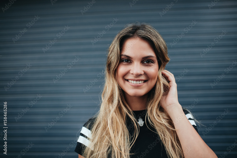 Fototapeta premium Young woman posing against gray background