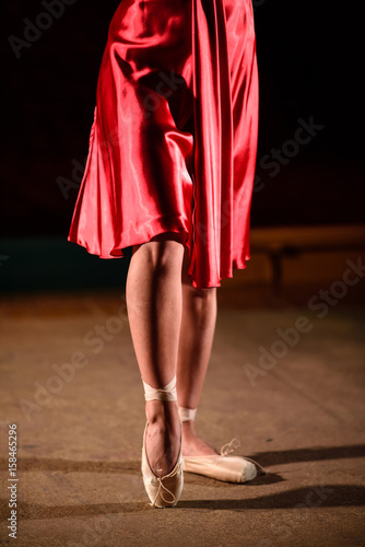 A girl in a red dress is dancing on stage. photo