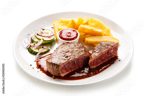 Grilled beefsteak with french fries on white background