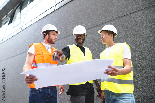 Three construction workers walking