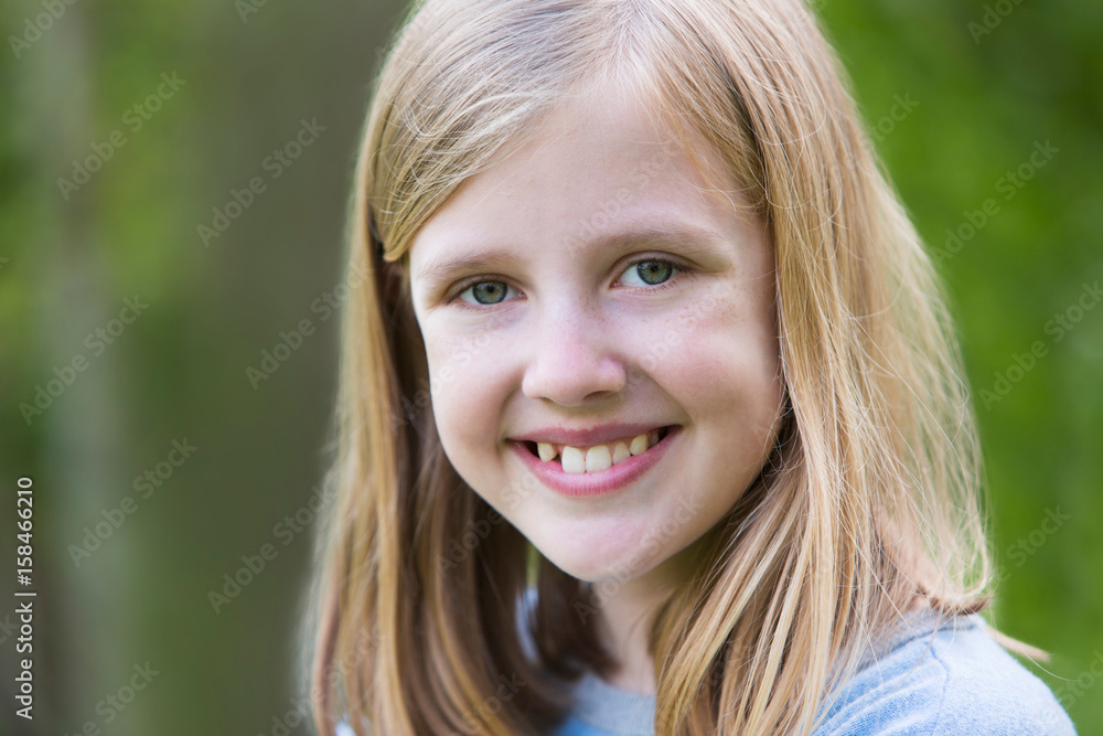 Portrait Of Smiling Pre Teen Girl Outdoors Portrait Of Smiling Pre Teen Girl Outdoors