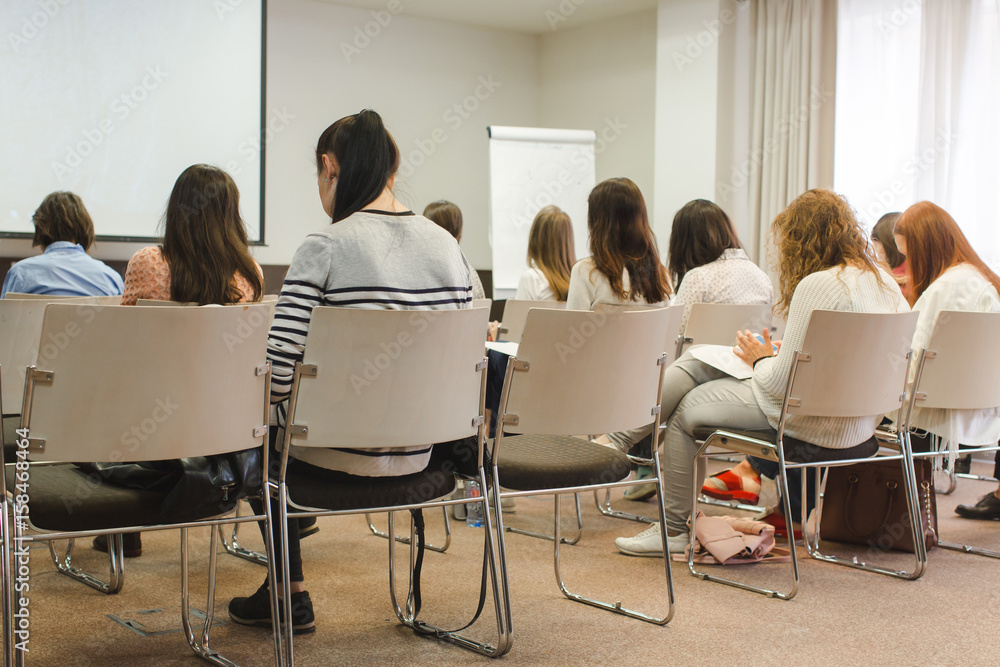Fototapeta premium Women student during study, in lecture Audience