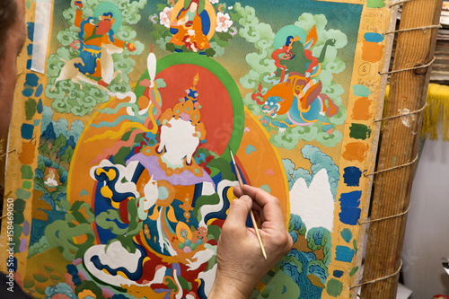 The artist paints a Buddhist icon