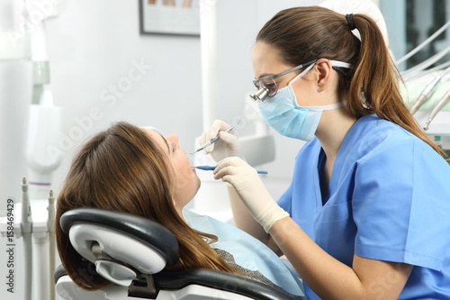 Dentist examining a patient teeth photo
