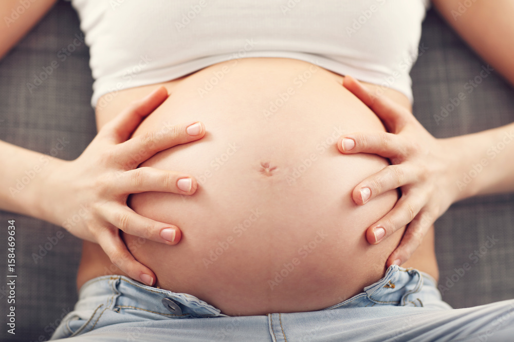 Happy pregnant woman resting on sofa Happy pregnant woman resting on sofa