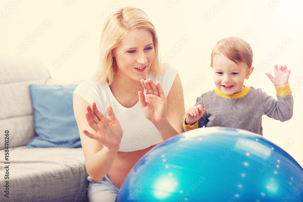 Young Happy Pregnant woman playing with son Young Happy Pregnant woman playing with son