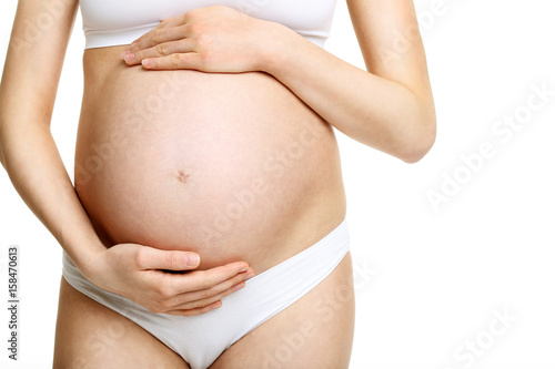 Wallpaper Mural Pregnant woman posing over white background Torontodigital.ca