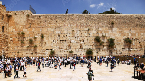 Western Wall or Wailing Wall or Kotel in Jerusalem timelapse. Plenty of people come to pray to the Jerusalem western wall. The Wall is the most sacred place for all jews on the planet. photo