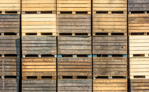 Stack of used wooden crates or boxes.