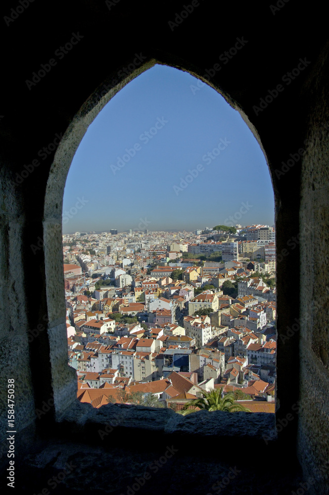 A down angle of the city Lisboa in Portugal viewed through an old window.