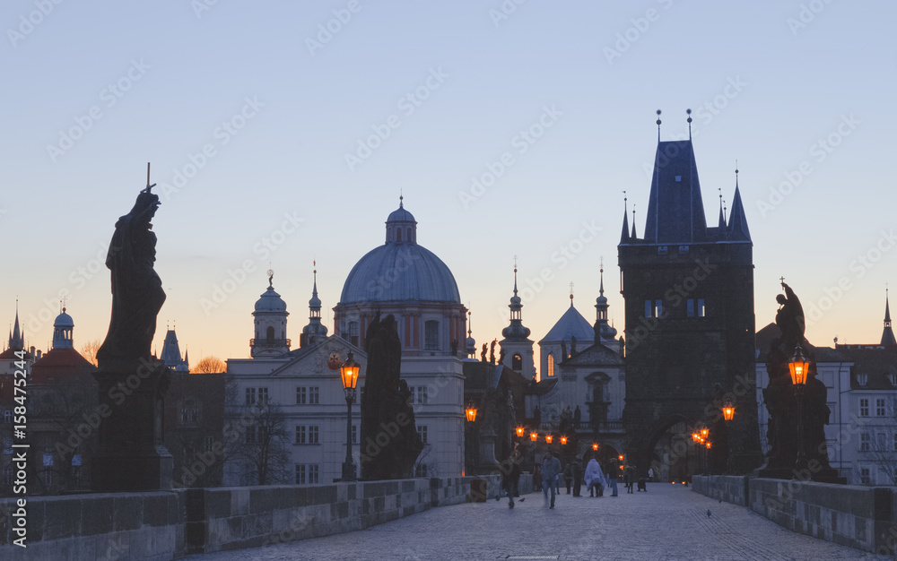 Charles bridge,  twilight scenery, street lights visible. Prague iconic travel destination, Czech Republic.  