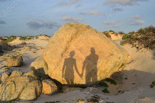 Silhouetted Shadows Holding Hands on Aruba's North Shore