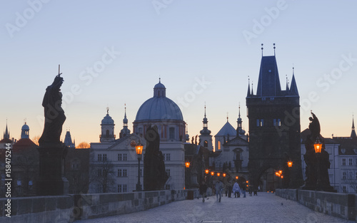 Charles bridge,  twilight scenery, street lights visible. Prague iconic travel destination, Czech Republic.   © Feel good studio