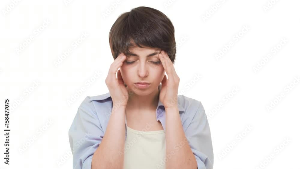 Concentrated Caucasian female with shirt dark hair holding temples suffering from terrible headache over white background Concentrated Caucasian female with shirt dark hair holding temples suffering from terrible headache over white background
