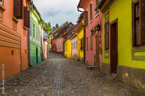 Sighisoara, Romania - lonely street with colorful houses. Discover Romania concept. © tonovavania